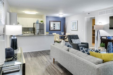 a living room and kitchen with a couch and a table
